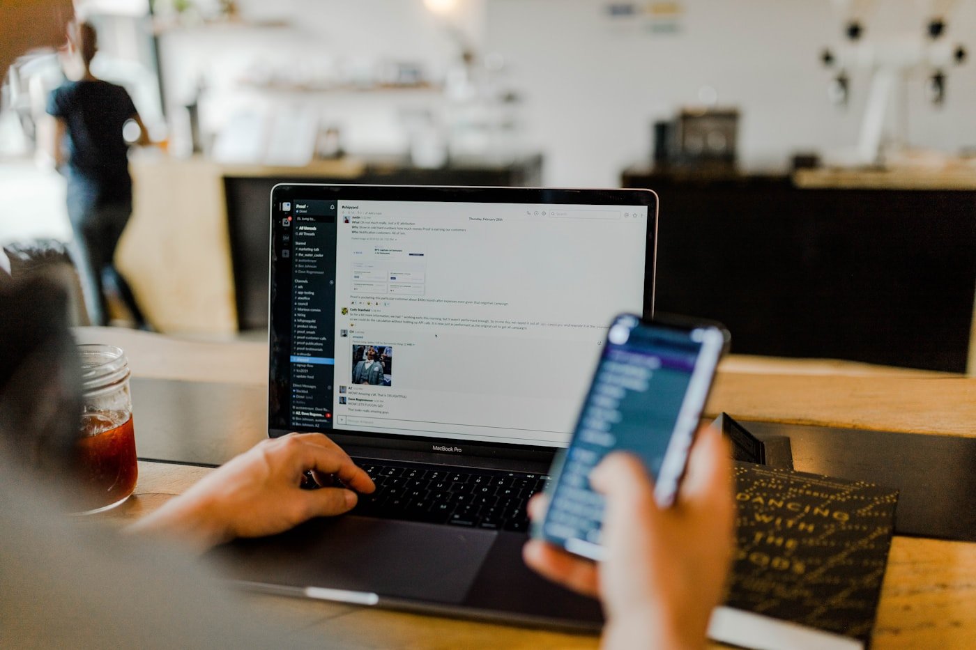 Professional working on a laptop and smartphone for website and digital project management