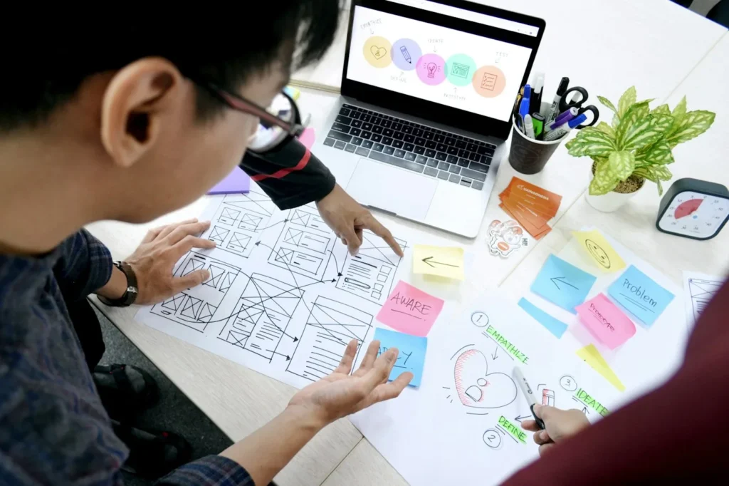 UI designers reviewing website wireframes before development